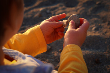 kid's hand holding a stone