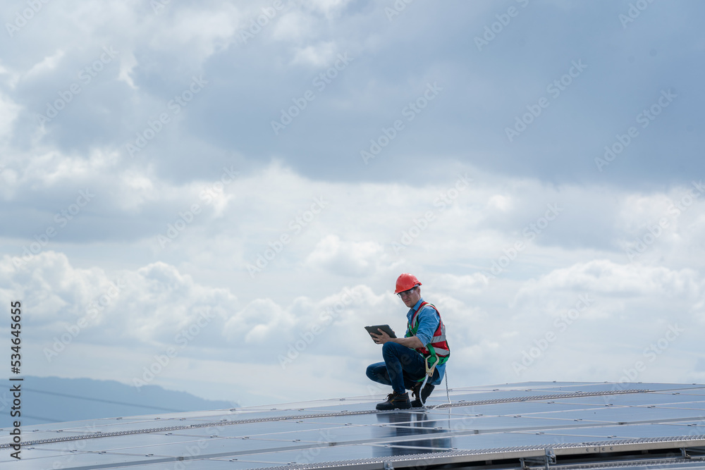 Poster engineer man or worker checking the operation of the system solar panels or solar cells on roof,rene