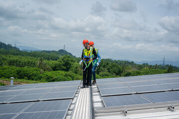 Engineers checking the operation of the system solar cell on roof at factory,Alternative energy to conserve the world's energy,Photovoltaic module idea for clean energy production.