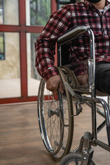 Male patient in wheelchair while waiting for a doctor's examination in a private room of a...