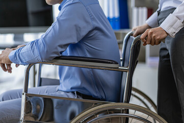 A female doctor pushes a male patient in a wheelchair in the hospital. Nursing care with man sitting on wheelchair asian women Caucasian men