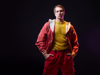 a young muscular man in a bright outfit poses in a pretentious pose, style and grotesque....