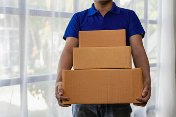 The delivery man was holding a pile of cardboard boxes in front of him. delivery concept white background