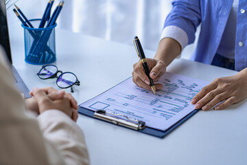 Young Asian woman holding resume while sitting in front of directors during company meetings or interviewing for business ideas, careers and employment positions.