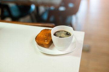 Diet set, a plate of one toast with a cup of black coffee