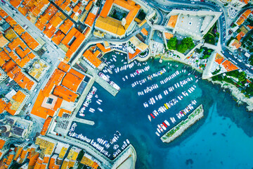 Aerial view down to the port of DUBROVNIK with yachts and boats. Sightseeing Croatia coast landmarks Cruise and travel in Croatia. Orange rooftops and architecture