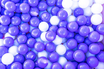 collection of purple and white balls in a boz