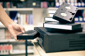 Close-up hand putt playback button on video record player concept of retro style or vintage...