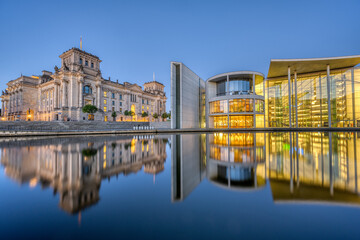 The Reichstag and part of the Paul-Loebe-Haus at the river Spree in Berlin at twilight