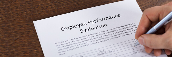 Person Filling A Performance Evaluation Form