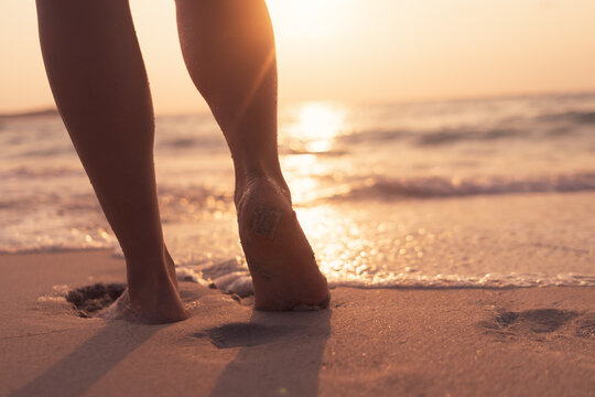 Woman Feet Walk Slow Life And Relax On Sand Tropical Beach With Blue Sky.