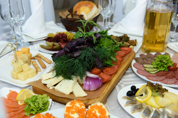 Festive table with food in the restaurant. Delicious food to treat guests.