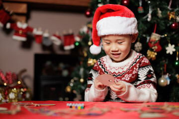 young girl making Christmas decorating card