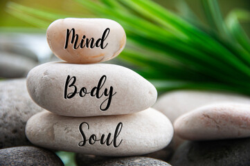 Mind, Body and Soul words engraved on zen stones with space for text. Copy space and zen concept