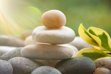 Light shining on zen stones with customizable space for text. Copy space and zen concept