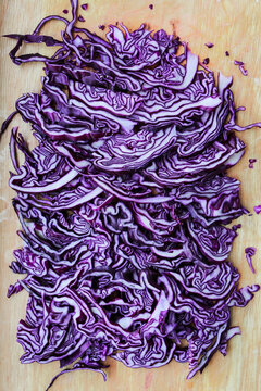 Finely shredded red cabbage. Bright purple background with abstract effect.