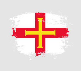 Obraz premium Elegant grungy brush flag with Guernsey national flag vector
