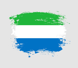 Fototapeta premium Elegant grungy brush flag with Sierra Leone national flag vector