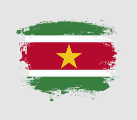 Elegant grungy brush flag with Suriname national flag vector