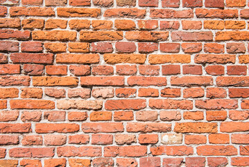 Obraz premium Old brick wall, orange, yellow, brown. Wall of an old vintage house. photo background.