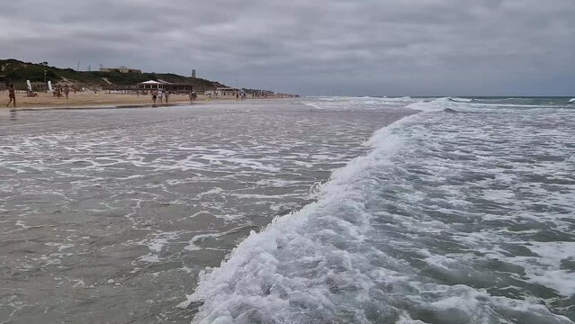 movement of the waves on the beach of La Barrosa in Sancti Petri, Cadiz