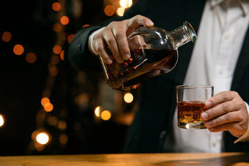 Barman pouring whiskey whiskey glass beautiful night
