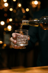 Barman pouring whiskey whiskey glass beautiful night