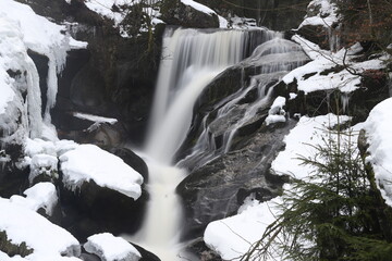 triberg waterfalls in winter with snow. Long exposure in fog, cold ice and bad weather in the Black...