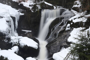 triberg waterfalls in winter with snow. Long exposure in fog, cold ice and bad weather in the Black...
