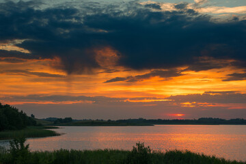 Fototapeta na wymiar Serene landscape with a lake lake in the evening