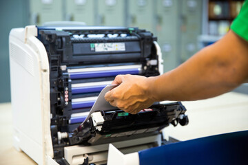 Technician hand open cover photocopier or photocopy to fix copier paper jam and replace ink...