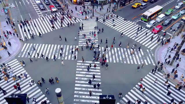 People passing the street crossing in Ginza district, Tokyo. Crosswalk. Intersection in Tokyo,Japan