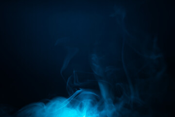 Blue smoke clouds in the dark abstract background. fog floating in air
