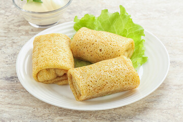 Stuffed pancakes with meat and cream