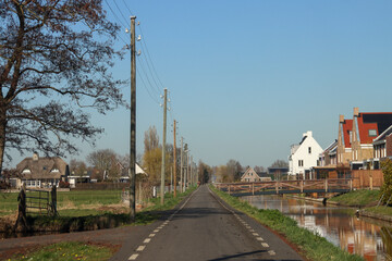 Fototapeta na wymiar Wooden poles with electricity wires in the Zuidplaspolder at the Vierde Tochtweg