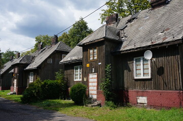 Fototapeta na wymiar Old wooden abandoned houses on Chorzowska Street. Swietochlowice, Poland.