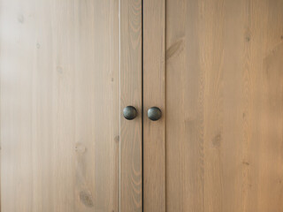Wooden cupboard doors with round handles. wood background
