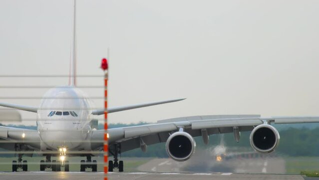 Passenger double deck airliner taxiing after landing at Dusseldorf airport, front view. Tourism and travel concept