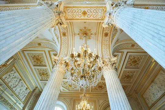 St. Petersburg, Russia - May 27, 2021: Hermitage Museum, large chandelier with gilding for hall lighting. Palace interior details.