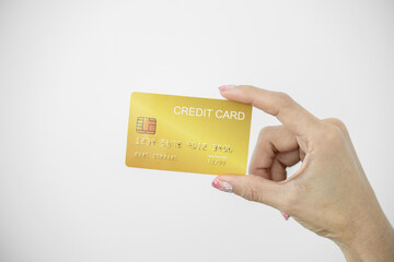 Woman holding bank business credit card on white background, Female hand holding bank credit card gold, Paying using credit card, shopping, lifestyle, copy space.