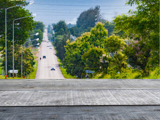 Old wooden table shelf in the background scenery  A highway surrounded by greenery