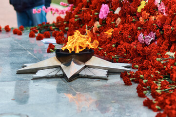 Flowers lay near the eternal flame.