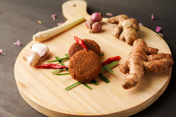 A side dish made from fish and a mixture of several ingredients then formed and then fried is often referred to as Tumpi - Tumpi.