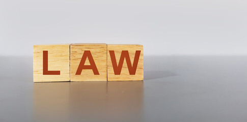 law letters on a wooden box on wooden box light gray background ,law management