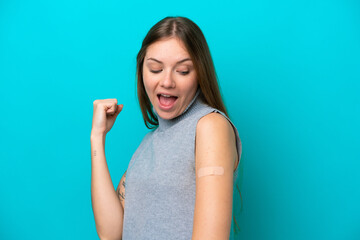 Young Lithuanian woman wearing band aids isolated on blue background celebrating a victory