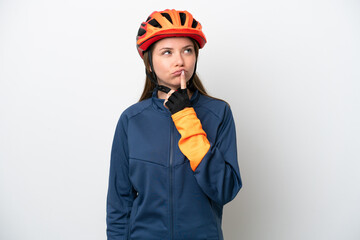 Young cyclist Lithuanian woman isolated on white background having doubts while looking up