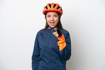 Young cyclist Lithuanian woman isolated on white background surprised and pointing front