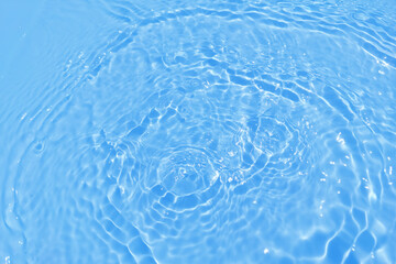 Obraz na płótnie Canvas Defocus blurred transparent blue colored clear calm water surface texture with splash, bubble. Shining blue water ripple background. Surface of water in swimming pool. Blue bubble water shining.