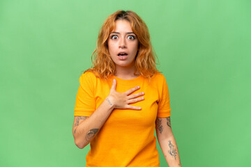 Young caucasian woman isolated on green screen chroma key background surprised and shocked while...