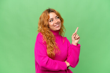Young caucasian woman isolated on green screen chroma key background pointing up a great idea - Powered by Adobe